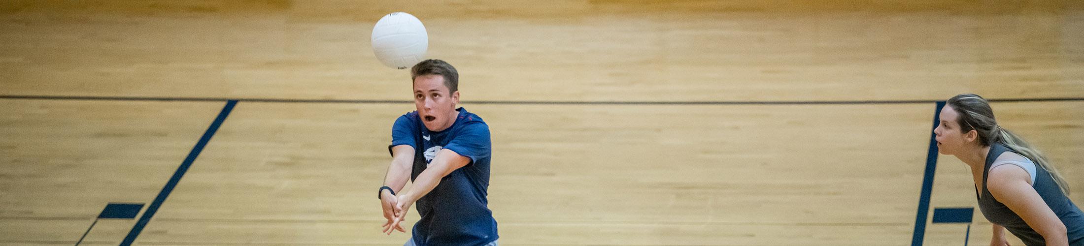 Students playing volleyball in rec center