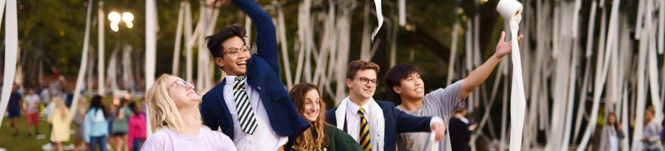 Students throwing toilet paper at Junk the Jungle.